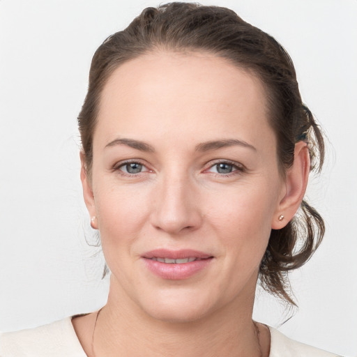 Joyful white young-adult female with medium  brown hair and grey eyes