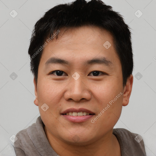 Joyful asian young-adult male with short  black hair and brown eyes