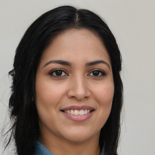 Joyful latino young-adult female with long  brown hair and brown eyes