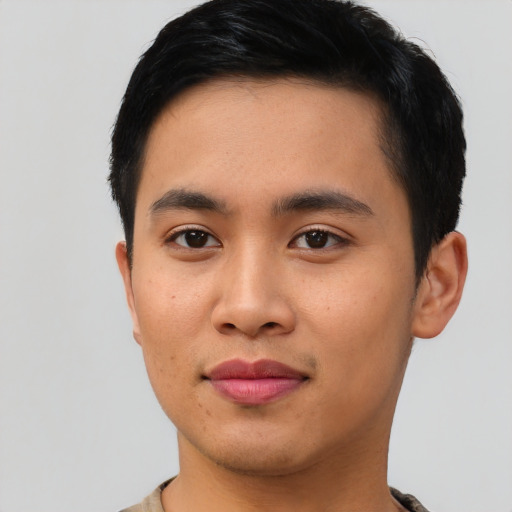 Joyful asian young-adult male with short  brown hair and brown eyes