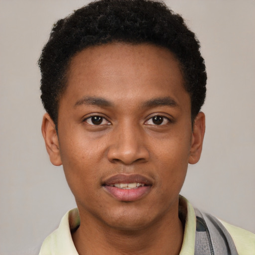Joyful latino young-adult male with short  brown hair and brown eyes