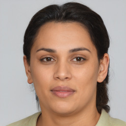 Joyful latino young-adult female with medium  brown hair and brown eyes