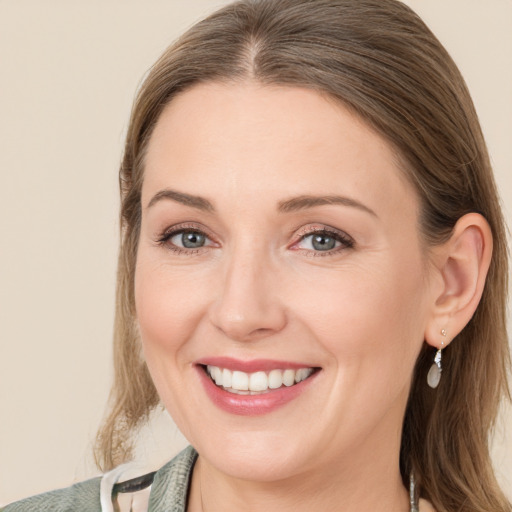 Joyful white young-adult female with medium  brown hair and blue eyes