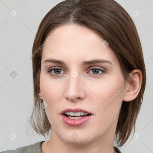 Joyful white young-adult female with medium  brown hair and grey eyes