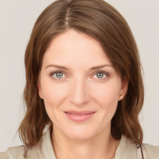 Joyful white young-adult female with medium  brown hair and green eyes