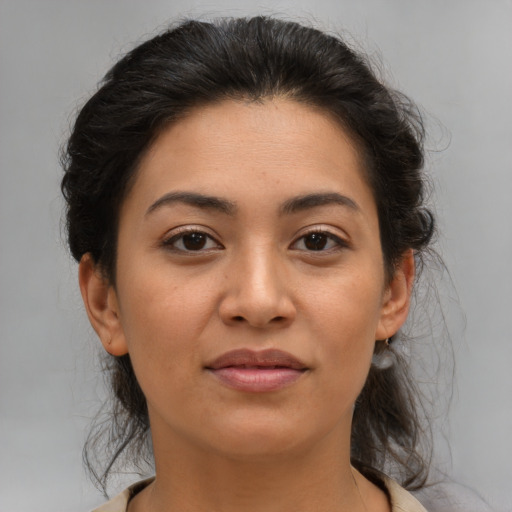 Joyful latino young-adult female with medium  brown hair and brown eyes