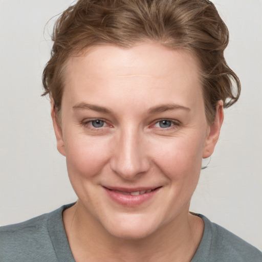 Joyful white young-adult female with medium  brown hair and blue eyes