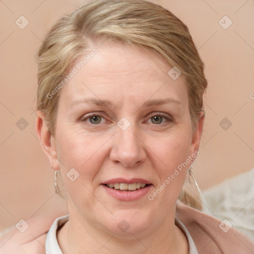 Joyful white adult female with medium  brown hair and blue eyes