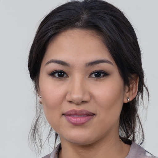 Joyful latino young-adult female with medium  black hair and brown eyes