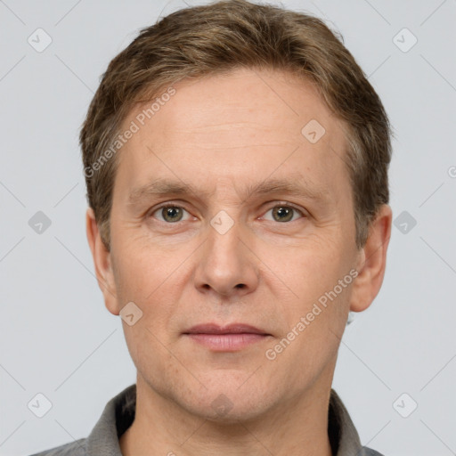 Joyful white adult male with short  brown hair and grey eyes