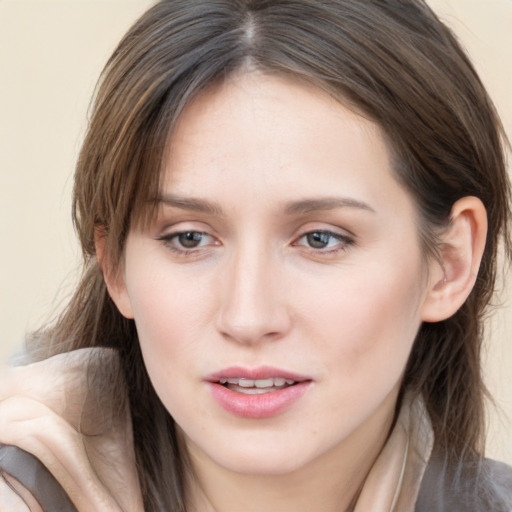 Joyful white young-adult female with medium  brown hair and blue eyes