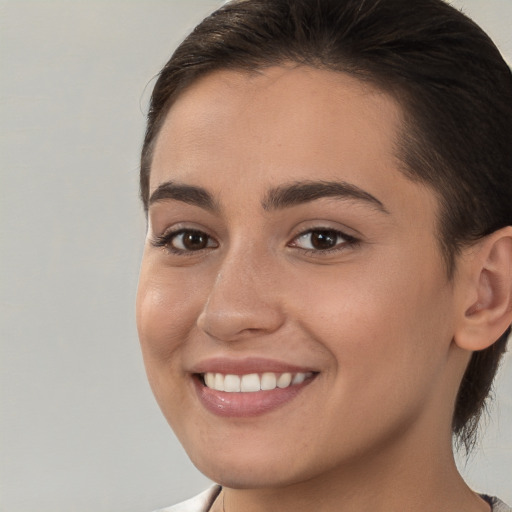 Joyful white young-adult female with medium  brown hair and brown eyes