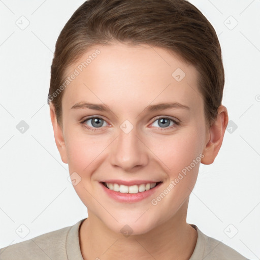 Joyful white young-adult female with short  brown hair and grey eyes