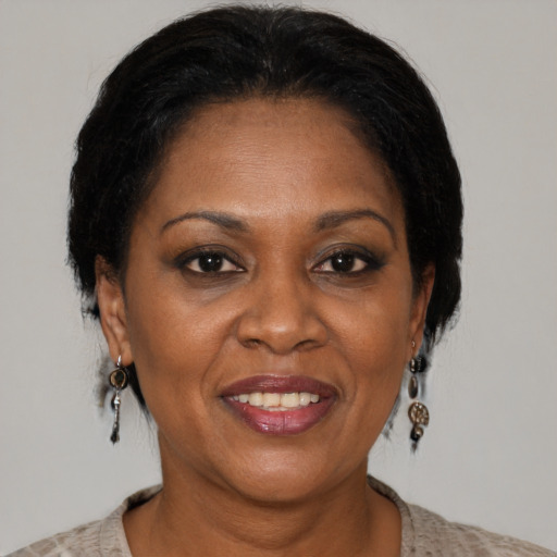 Joyful black adult female with short  brown hair and brown eyes