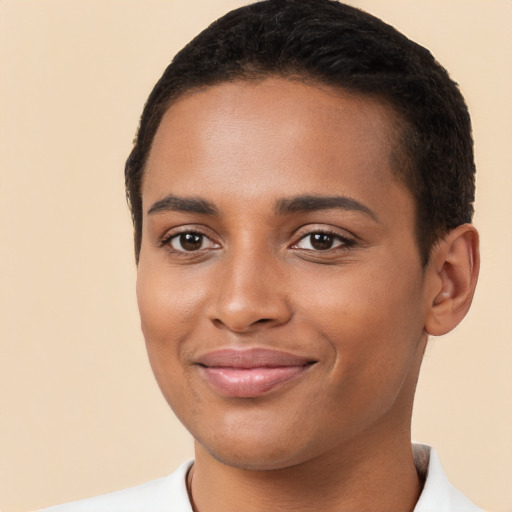 Joyful black young-adult female with short  brown hair and brown eyes