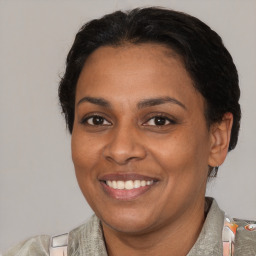 Joyful black adult female with short  brown hair and brown eyes