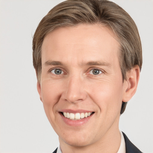 Joyful white adult male with short  brown hair and grey eyes