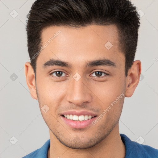 Joyful white young-adult male with short  brown hair and brown eyes