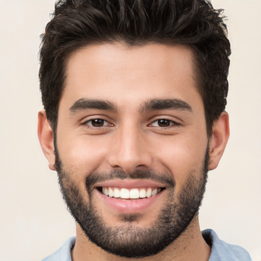 Joyful white young-adult male with short  black hair and brown eyes