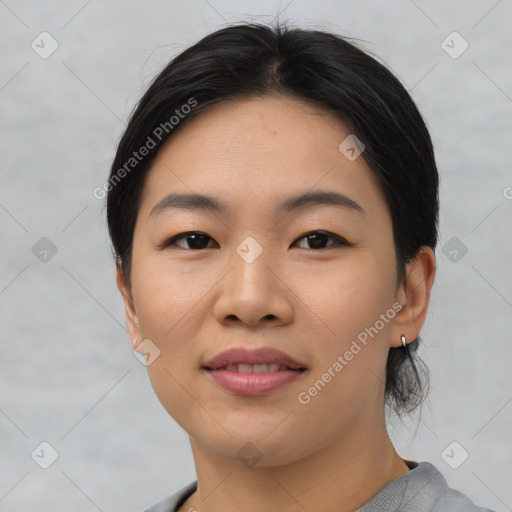 Joyful asian young-adult female with short  black hair and brown eyes