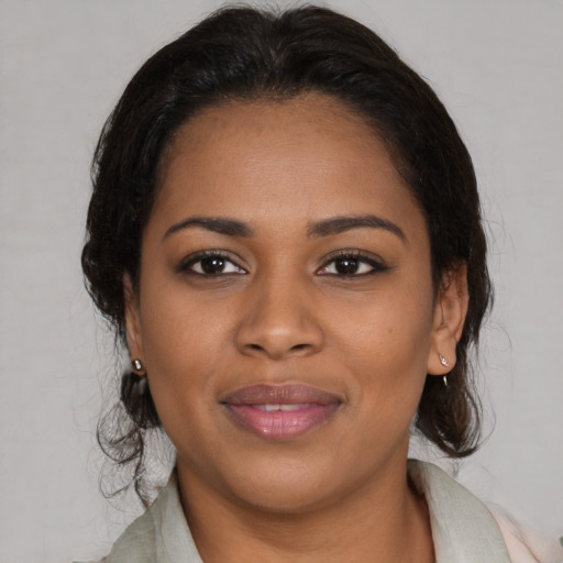 Joyful black young-adult female with medium  brown hair and brown eyes