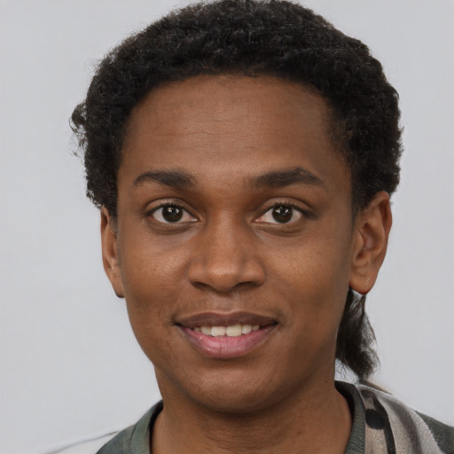 Joyful black young-adult male with short  black hair and brown eyes