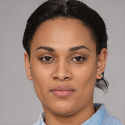 Joyful latino young-adult female with short  brown hair and brown eyes