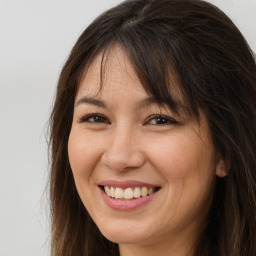 Joyful white adult female with long  brown hair and brown eyes