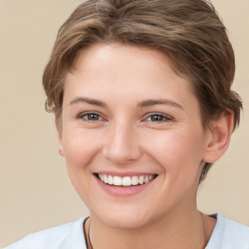 Joyful white young-adult female with short  brown hair and brown eyes