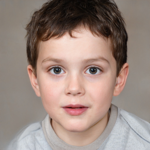 Joyful white child male with short  brown hair and brown eyes