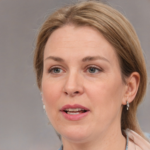 Joyful white adult female with medium  brown hair and grey eyes