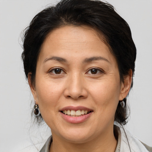 Joyful white adult female with medium  brown hair and brown eyes