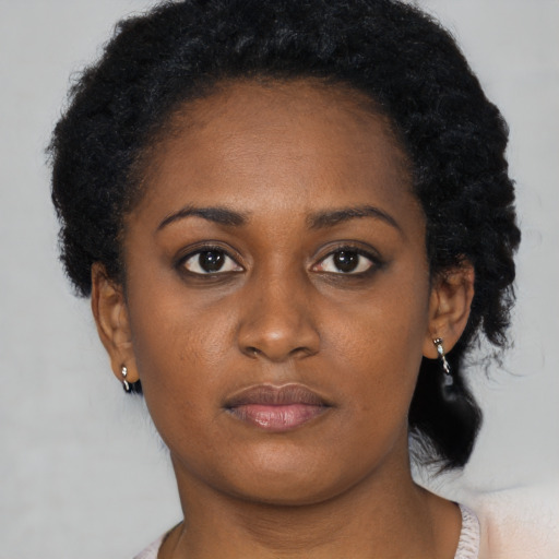 Neutral black young-adult female with short  black hair and brown eyes