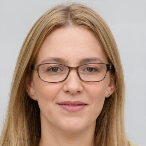 Joyful white adult female with long  brown hair and green eyes