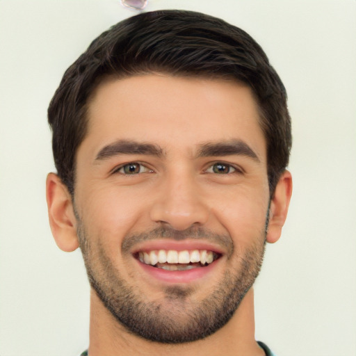 Joyful white young-adult male with short  black hair and brown eyes