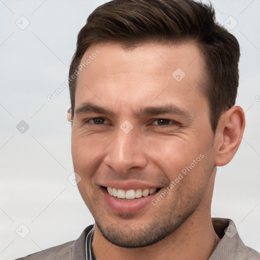 Joyful white young-adult male with short  brown hair and brown eyes