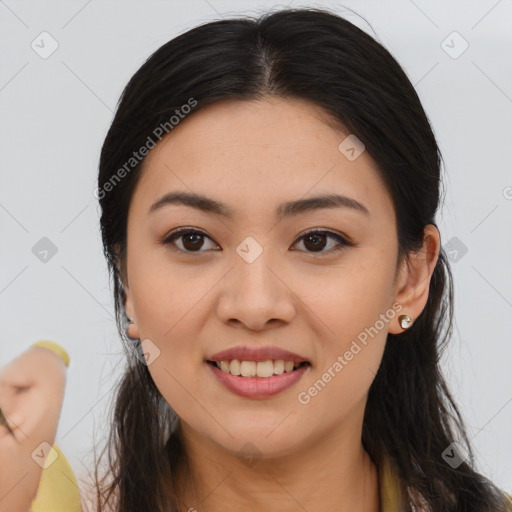 Joyful asian young-adult female with long  brown hair and brown eyes