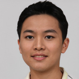 Joyful asian young-adult male with short  black hair and brown eyes