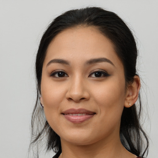 Joyful latino young-adult female with long  brown hair and brown eyes