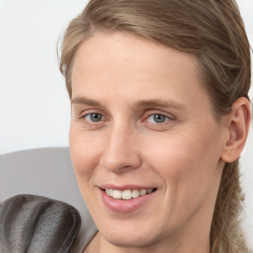 Joyful white young-adult female with medium  brown hair and blue eyes