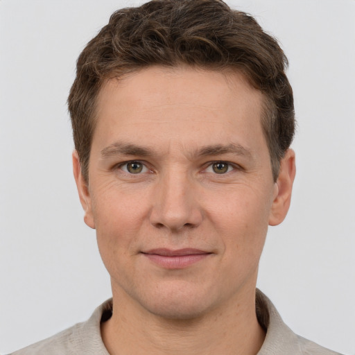 Joyful white adult male with short  brown hair and grey eyes