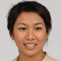 Joyful asian young-adult female with short  brown hair and brown eyes