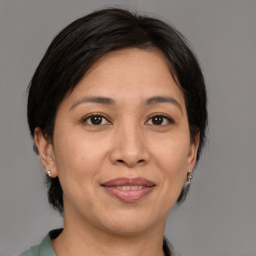 Joyful white adult female with medium  brown hair and brown eyes