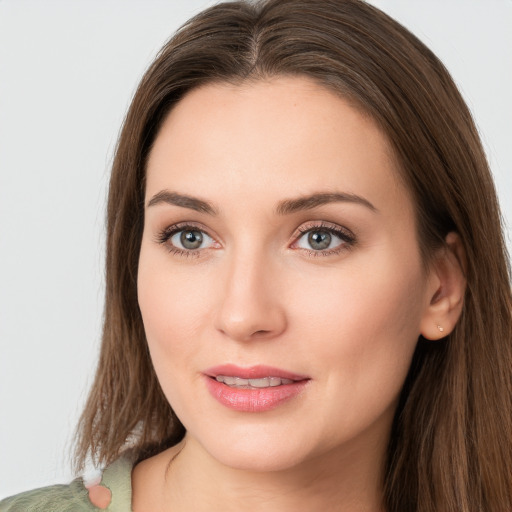 Joyful white young-adult female with long  brown hair and green eyes