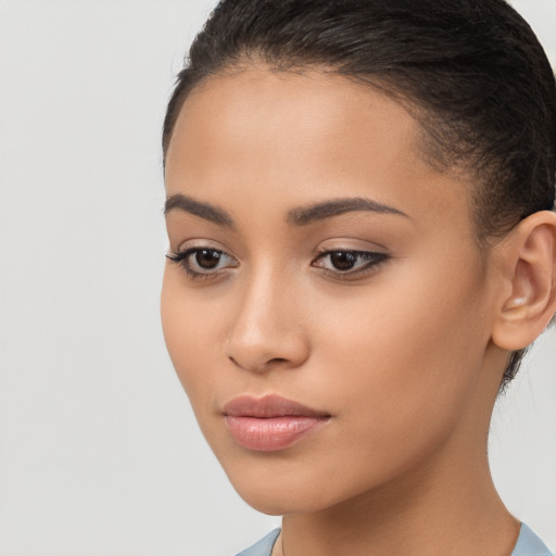 Joyful latino young-adult female with long  brown hair and brown eyes