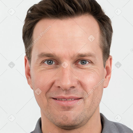 Joyful white adult male with short  brown hair and grey eyes