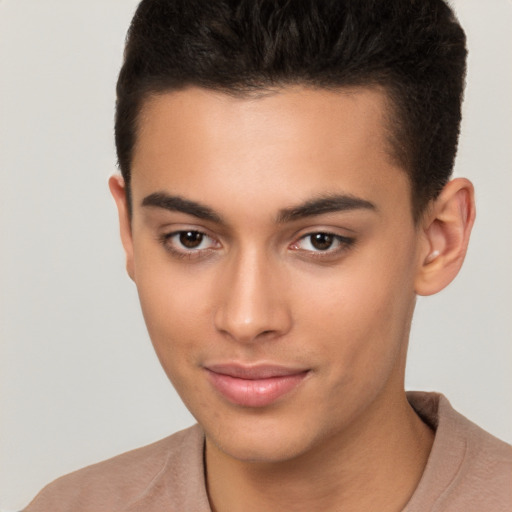 Joyful latino young-adult male with short  brown hair and brown eyes