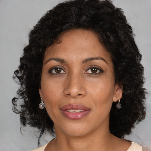 Joyful black young-adult female with medium  brown hair and brown eyes