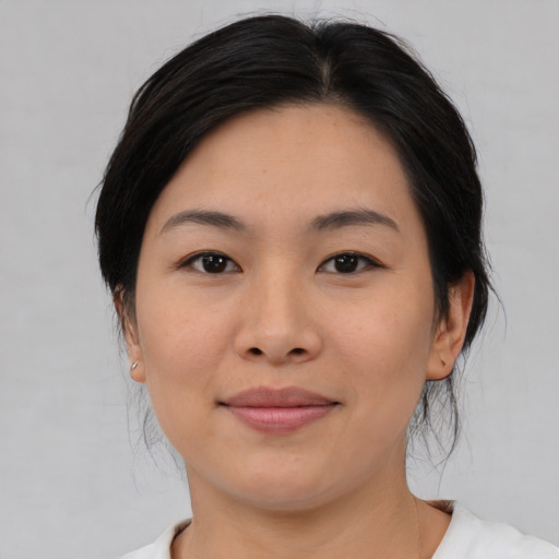Joyful asian young-adult female with medium  black hair and brown eyes