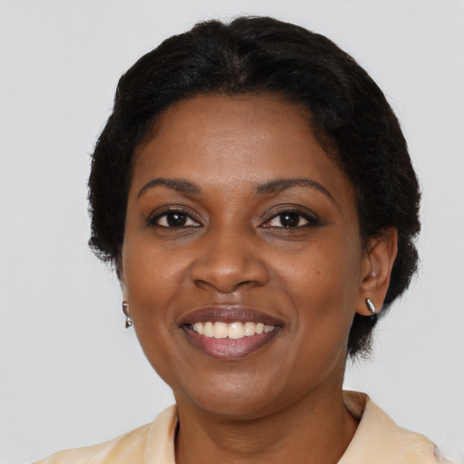 Joyful latino adult female with medium  brown hair and brown eyes